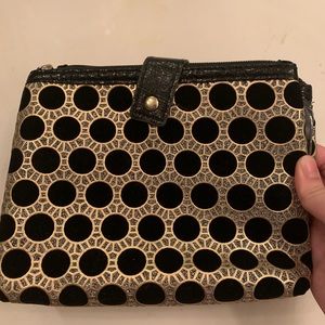 Dior gold and silver makeup bag.